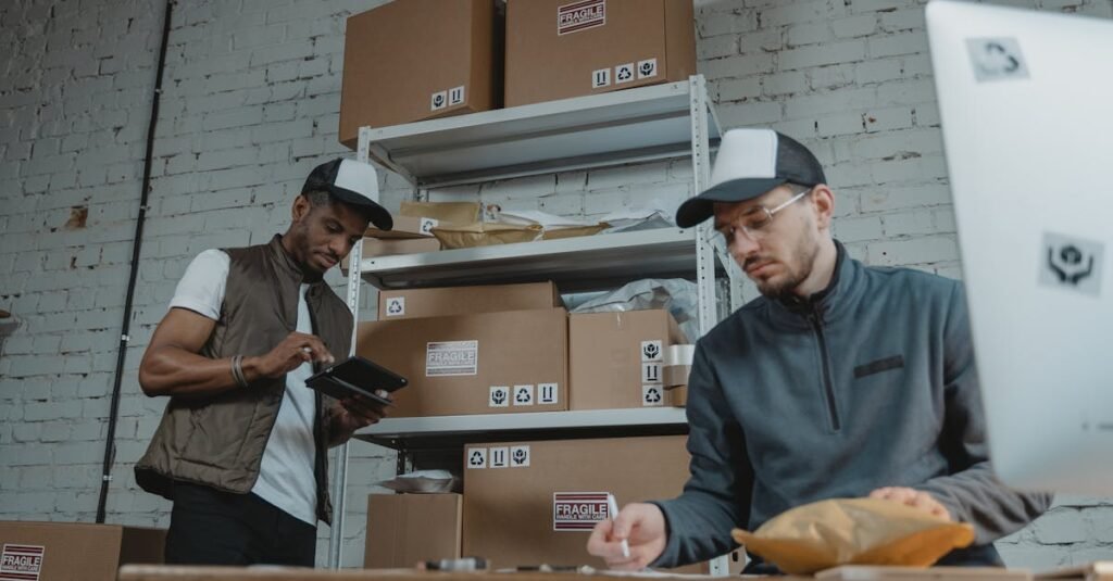 pexels-photo-6169650-6169650 Two warehouse employees organizing and packing parcels for delivery in a modern indoor setting.